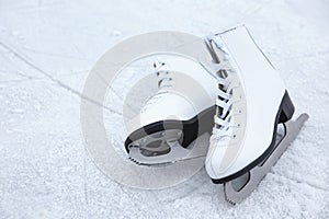 Pair of figure skates on ice. Winter outdoors activities