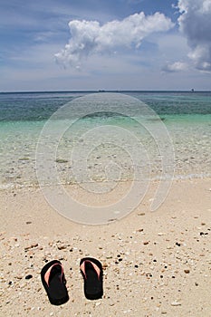 Pair of flip-flops on Ilig Iligan Beach, Boracay Island, Philippines