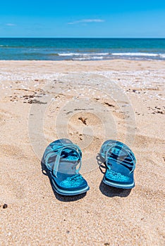 A pair of flip flops on a sandy beach in Bulgaria