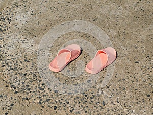 a pair of flip-flops stuck on the sand of a beach photo