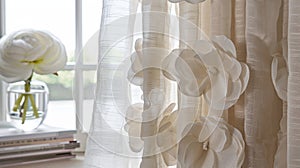 A pair of flowy curtains adorned with subtle petalshaped outs. photo