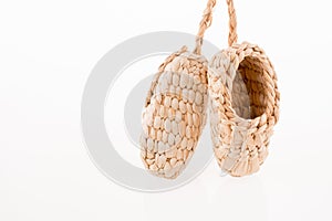 Pair of footware made of straw photo