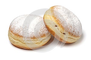 Pair of fresh baked Berliner donuts covered with white sugar close up