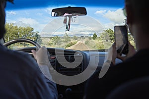 Pair of friends traveling by car in Los Gigantes, Cordoba, Argentina