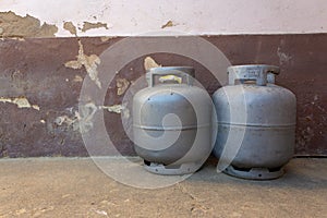 Pair of gas next to a old wall