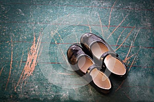 Pair of Girl Shoes on old blackboard