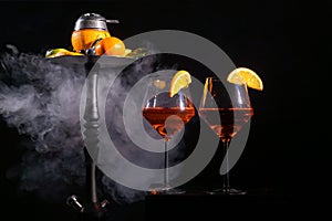 Pair of glasses with alcoholic drink beverage wine and hookah with fruits