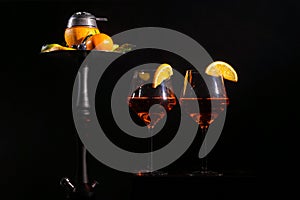 Pair of glasses with alcoholic drink beverage wine and hookah with fruits