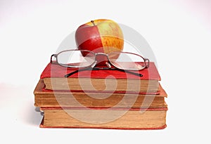 A pair of glasses and a apple