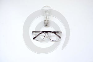 A pair of glasses and a light bulb