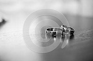 A pair of gold wedding rings on a brown background. Wedding rings on wooden background