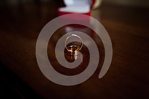 A pair of gold wedding rings on a brown background. Wedding rings on wooden background