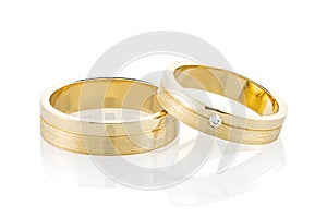 Pair of gold wedding rings isolated on white background