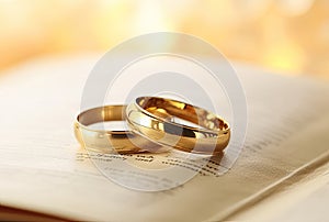 Pair of gold wedding rings on a prayer book
