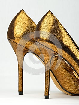 Pair of golden colored High Heels