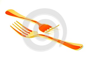 Pair of golden forks on white background with abstract reflections