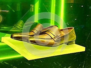 pair of golden shoes in the shop window