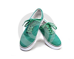 A pair of green canvas shoes isolated on white