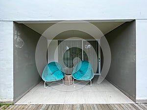 A pair of green lounge chairs in front of the room