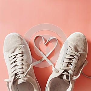 Pair of grey runners with laces making a heart shape