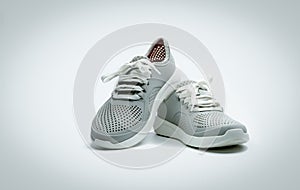 A pair of grey shoes on white background. Comfortable shoes with pore. Breathable rubber shoes. Footwear
