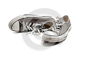 A pair of grey sneakers on white