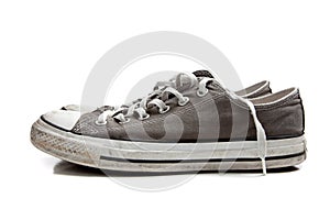 A pair of grey sneakers on white