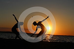 A pair of gymnasts athletes. Silhouette photo