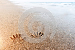 hand prints on the sand