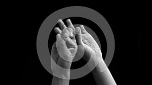 Pair of hands coming up and showing or teaching or demonstrating step of Bharatnatyam isolated on black background.