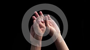 Pair of hands coming up and showing or teaching or demonstrating step of Bharatnatyam isolated on black background.