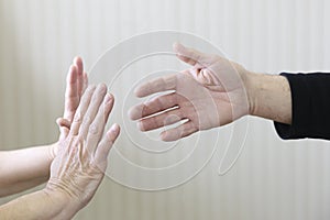 Pair of hands in defensive motion to stop handshake