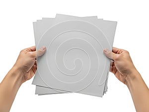 Hands holding a stack of gray paper sheets