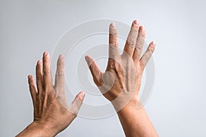 Pair of hands reaching up