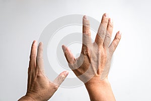 Pair of hands reaching up