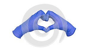 Pair of hands wearing blue nitrile examination gloves come together to make a heart or love gesture