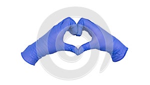 Pair of hands wearing blue nitrile examination gloves come together to make a heart or love gesture photo
