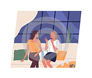 Pair of happy young girls sitting on couch and talking. Two female friends chatting at cafe. Women spending time