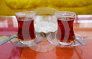 Pair of Hot Turkish Tea with Plate of Sugar Cubes in the Backdrop