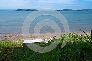 Pair of jandals and empty pizza box left by beach on scenic Man O War Bay on Waiheke Island New Zealand photo