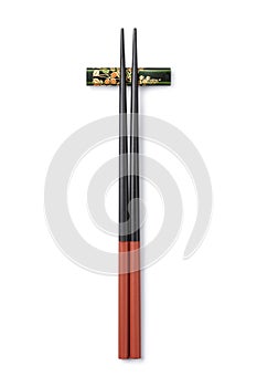 Pair of Japanese chopsticks on a chopstick rest on white background