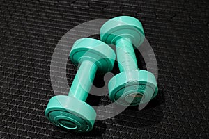 A pair of 1kg. dumbbells in green color. photo