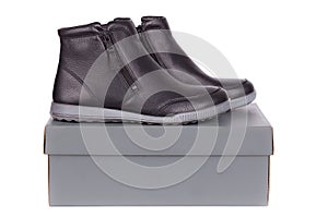 A pair of leather female low boots on top of box