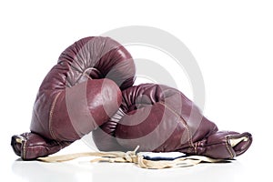 A pair of leather vintage boxing gloves on white background