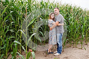 Pair of lovers canoodle in the corn field