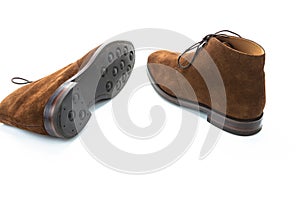 Pair of Male Brown Suede Chukka Boots Placed Randomly Together On White Background
