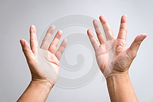 Pair of male hands raising up and reaching out gesture