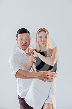 a pair of man and woman lovers embrace on a white background