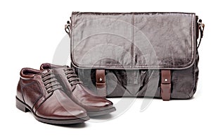 Pair of men boots and messenger bag over white