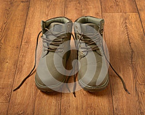 Pair of mountain shoes on wooden table